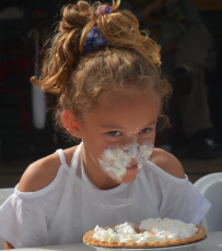 (Lorrie Ross • Clay County Progress) The pumpkin pie eating contests held at 2:30 p.m. each day are popular for all ages. Young and old are cheered on as they each eat their way through a pumpkin pie, covered with whipped cream.