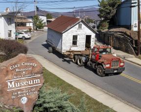 The old Hayesville Town Hall came slowly down Main Street on equipment provided by Smith House Movers.