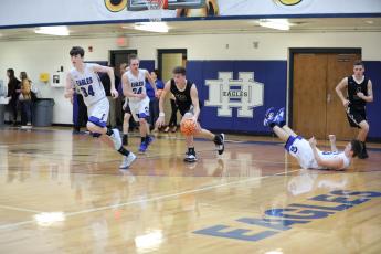 (Kelli Graves * Clay County Progress) Jake McTaggart leaves an Eagle in his wake as he rumbled up the floor.