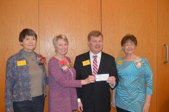 (Lorrie Ross • Clay County Progress) Erlanger Western Carolina CEO Mark Kimball accepts a check for $72,550 from Granny's Attic officers, from left, Sandy Jersey, Karen Robinson, Kimball and Debbie Thrower.