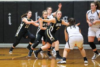 The trio of Annessca Guyette, Lila Roberts and Kaylee Leath- erwood clog the lane against Robbinsville.