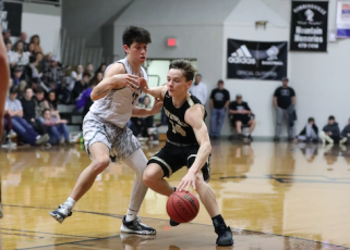 (Kelli Graves • Clay County Progress) Point guard Kolbe Ashe tries to create room to work against the Black Knights.