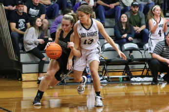 (Kelli Graves • Clay County Progress) Sophomore Lila Payne lowers a shoulder and drives past a Lady Knight and towards the basket.