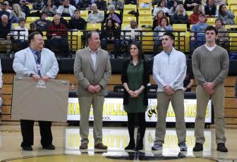 (Kelli Graves • Clay County Progress) Hayesville head coach Mike Cottrell, flanked by HHS principal Jim Saltz to his right and wife Jenny, and sons Josh and Zach to his left, is honored for his 400th win as coach of the Yellow Jackets.