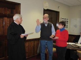 (Progress photo • Lorraine Bennett)  Judge Willis Whichard, left, retired from the N.C. Supreme Court, administers the oath   of office to incoming Hayesville Mayor Joe Slaton as wife Wendy holds the Bible.