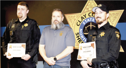 (Becky Long • Clay County Progress) Clay County deputies Justin Osborn, left, and Kyle Lickteig, on right, receive Letters of Commendation from Sheriff Bobby Deese during a brief recognition luncheon on Thursday, Feb. 17. The deputies were distinguished for saving two lives after drug overdose.
