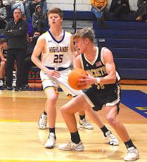 Gary Corsair • Clay County Progress Hayesville's Isaac Chandler, No. 11, looks to make an outlet pass after corralling a defensive rebound. Chandler had a game-high 11 caroms.